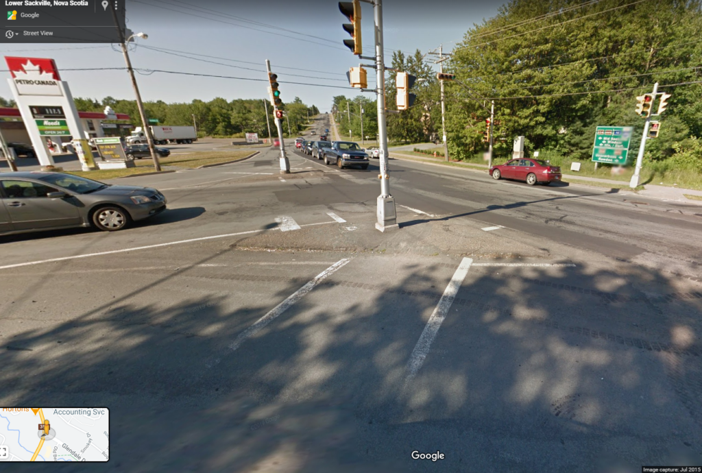 Crosswalk leading to a pedestrian traffic island that is not fully raised from roadway. 