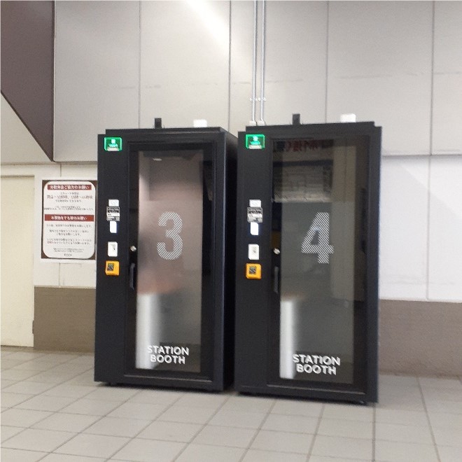 Two booths standing side-by-side in a larger indoor space. 