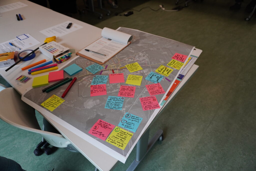 A poster-sized map of Bridgewater on a desk with colourful sticky notes stuck to it.