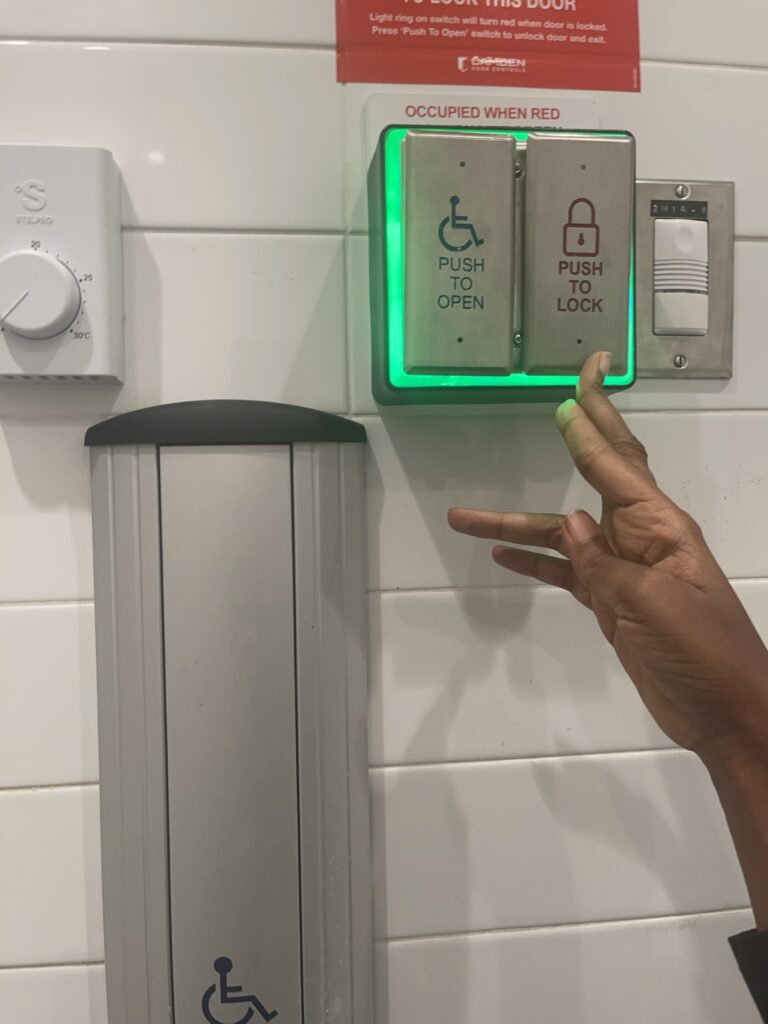 Two buttons with green light indicating door is unlocked.
